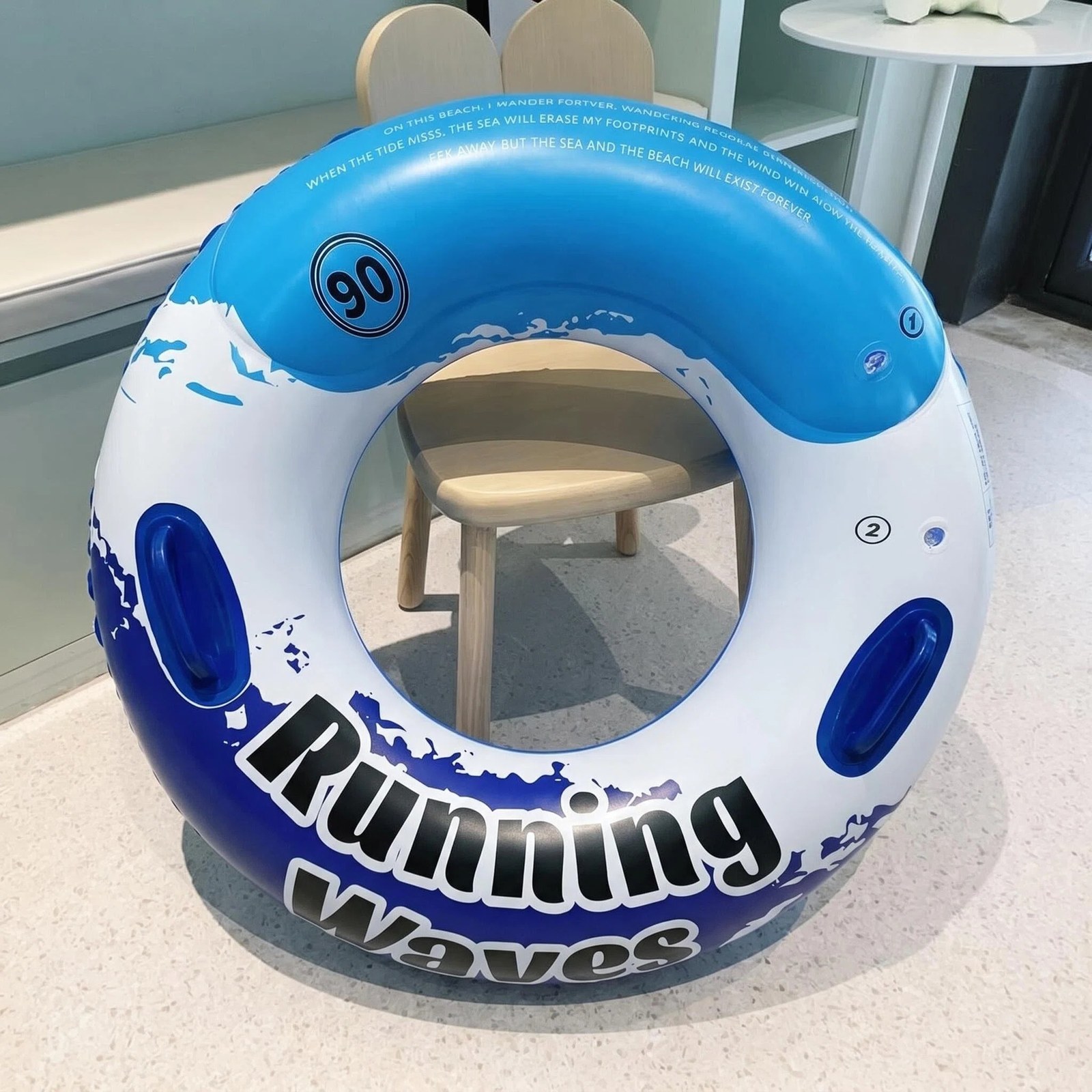 Blue inflatable pool ring with dual handles